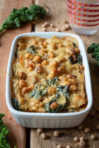 Auflaufform mit veganer Grünkohl-Lasagne auf einem Holztisch