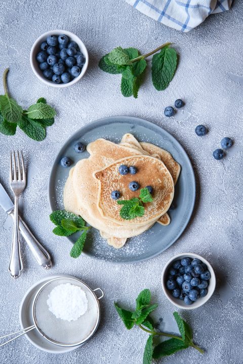 Vegane Pfannkuchen aus nur zwei Zutaten, dekoriert mit Heidelbeeren und Minzblättern